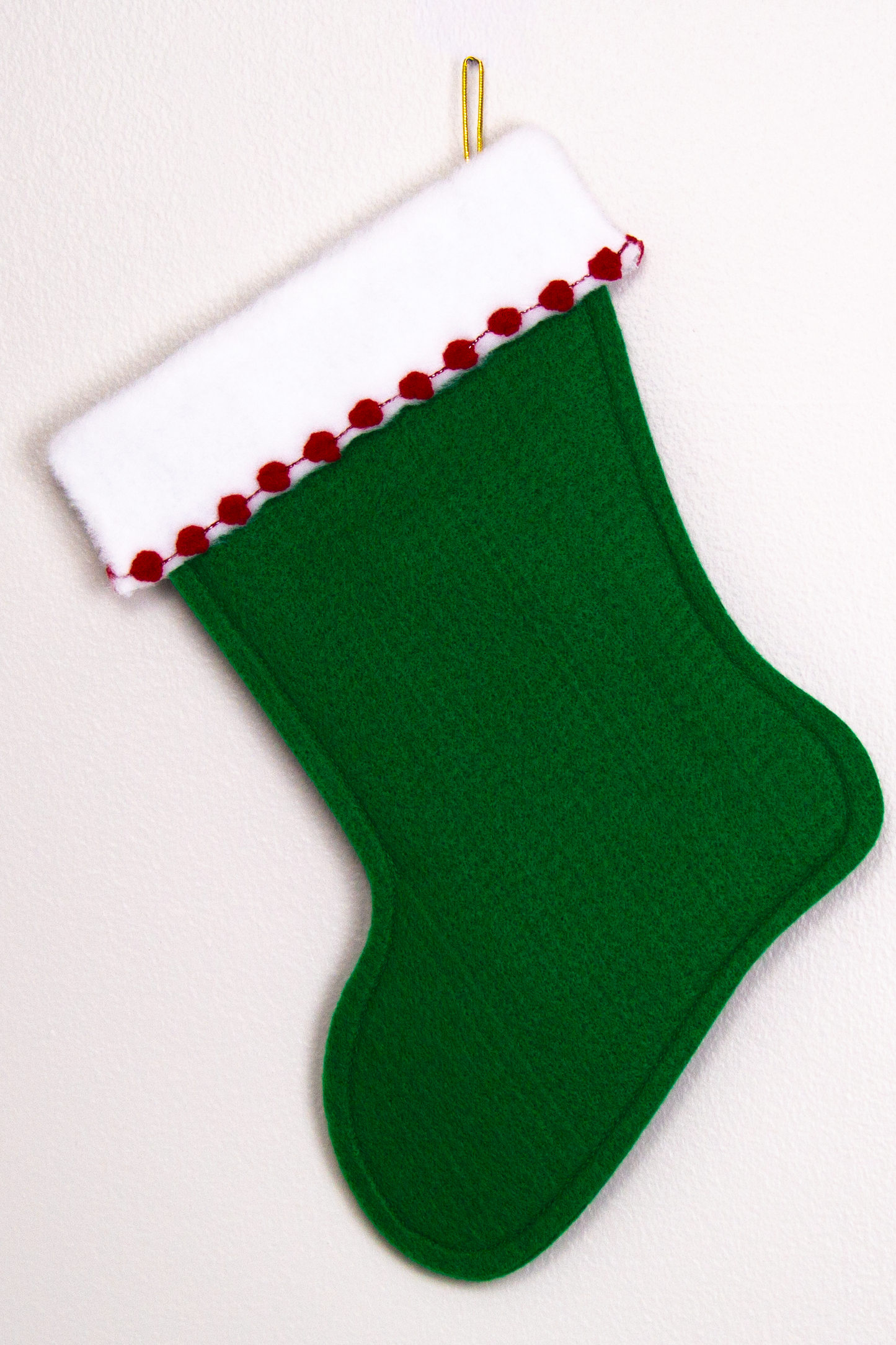 Holiday green felt handmade Christmas stocking with poms and decoration in  red & gold. (back of triangle Santa stocking)