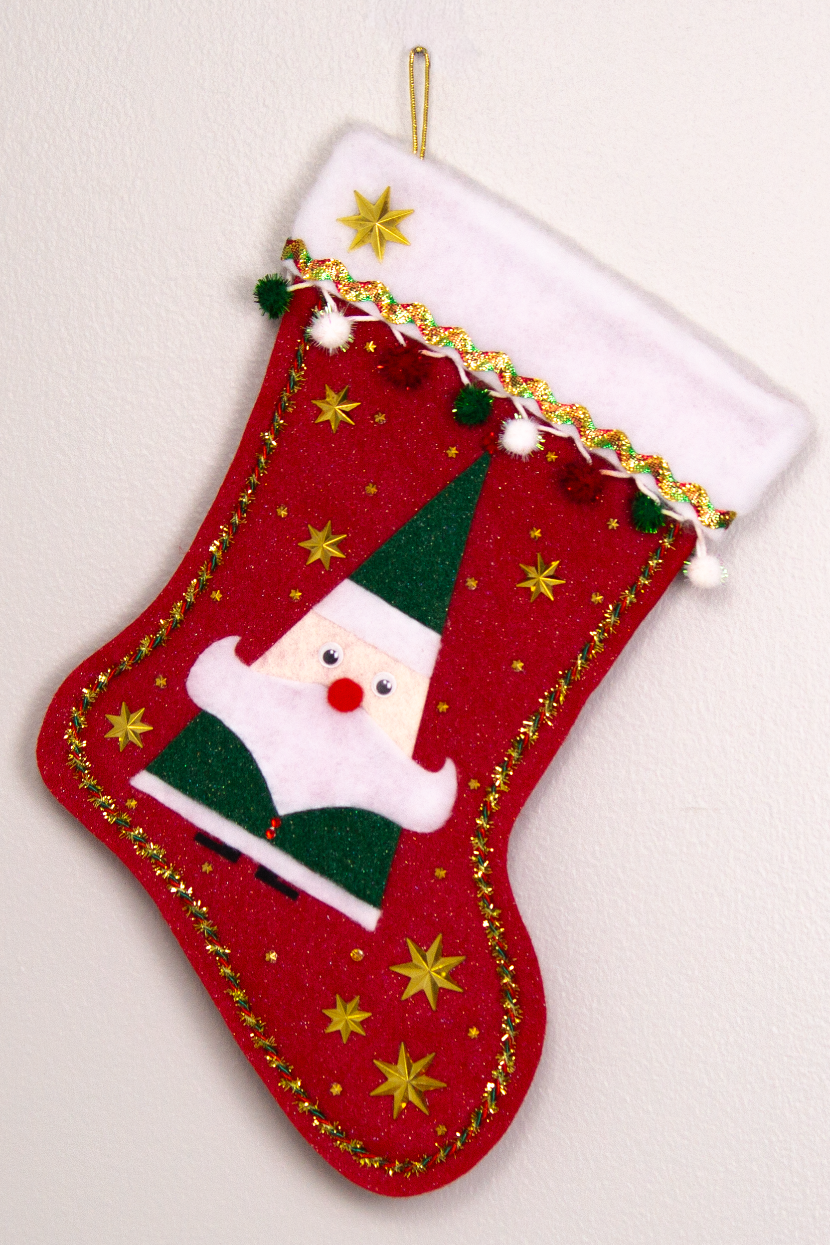 Triangular Santa (Holt Howard for Libbey inspired) in a glitter dark green suit on red glitter felt handmade Christmas stocking with star buttons, sparkly pom poms and decoration in red, green, white & gold. (front of stocking)