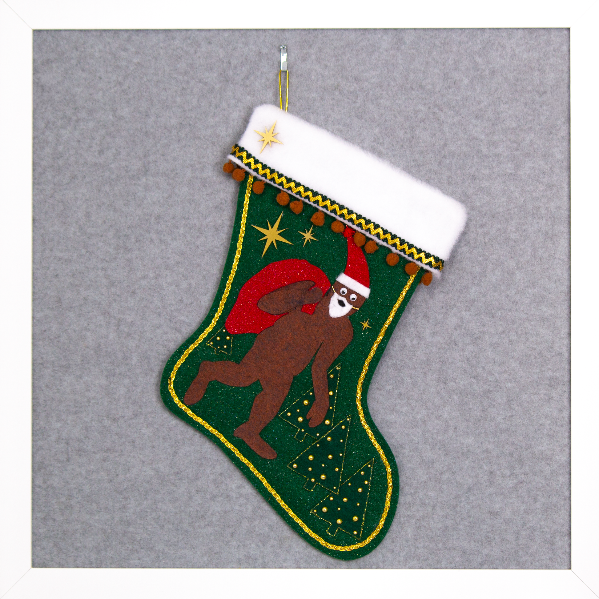 Felt Sasquatch Santa, red glitter bag/hat on dark green glitter felt handmade Christmas stocking with pom poms, trees, acrylic starbursts and decorated in brown, red & gold. (front of stocking)