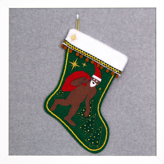 Felt Sasquatch Santa, red glitter bag/hat on dark green glitter felt handmade Christmas stocking with pom poms, trees, acrylic starbursts and decorated in brown, red & gold. (front of stocking)