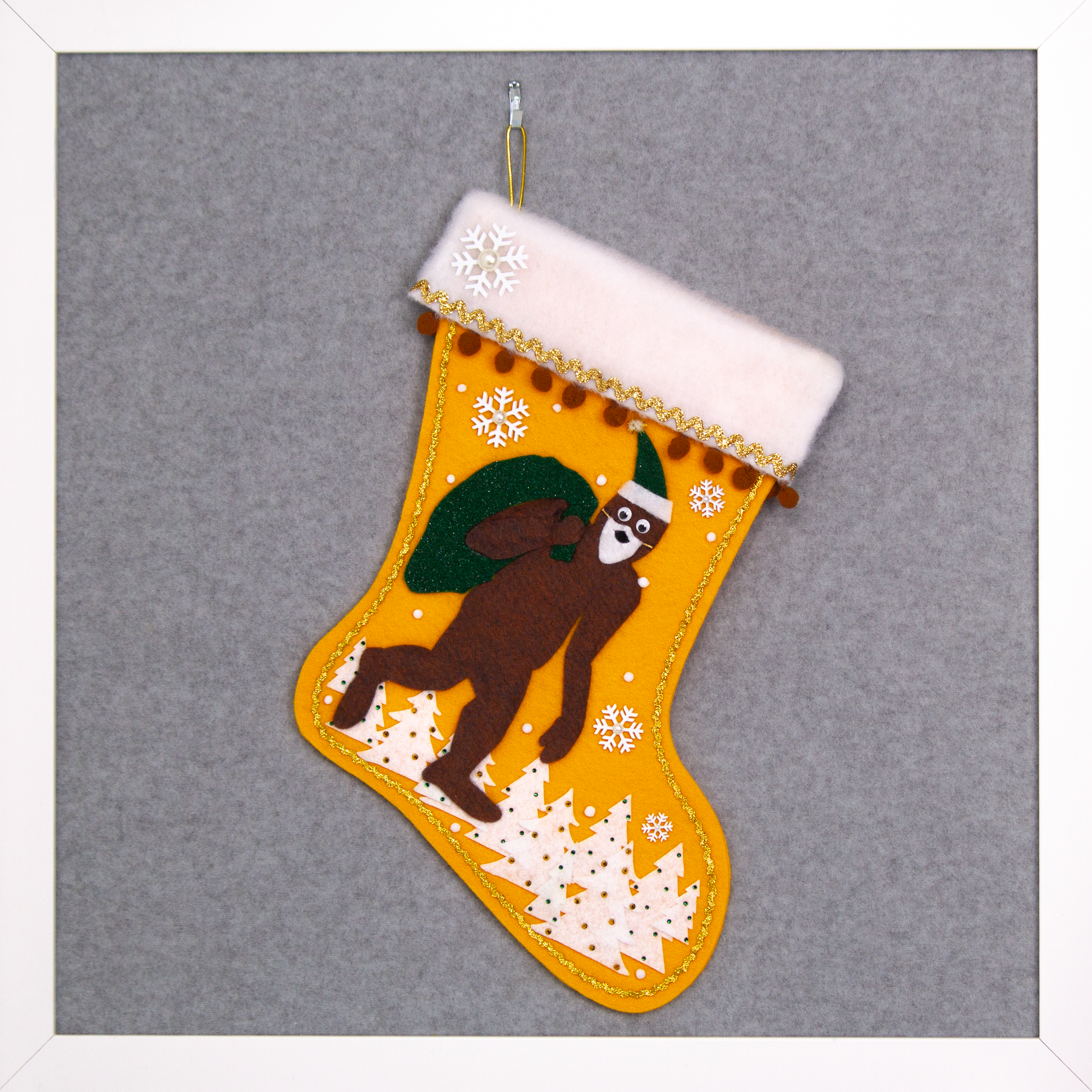 Felt Sasquatch Santa, dark green glitter bag/hat on golden felt handmade Christmas stocking with pom poms, trees and snowflake buttons decorated in white, brown & gold. (front of stocking)