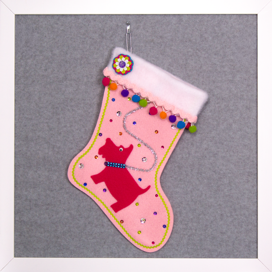 Bright pink Scottish Terrier Scottie dog on light pink felt handmade Christmas stocking with colorful pom poms and decorated in silver, pink, orange, purple, blue & green. (front of stocking)