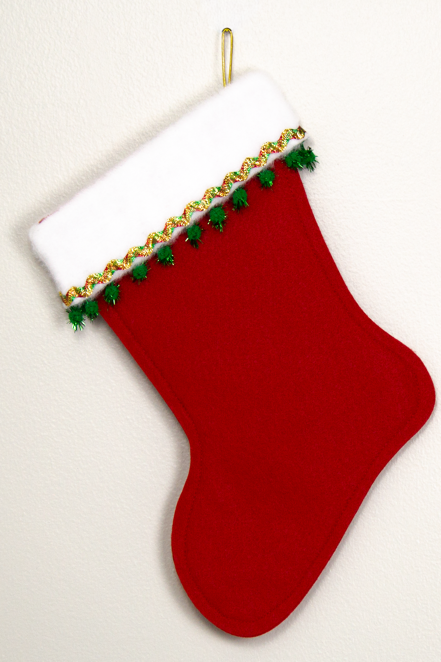 Holiday red felt handmade Christmas stocking with sparkly pom poms, metallic trim and decorations in red, green & gold. (back of Shih Tzu dog stocking)