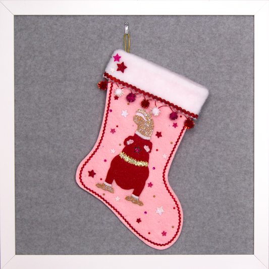 Gold glitter T-Rex with a red glitter felt suit on light pink felt handmade Christmas stocking with sparkly pom poms, felt glittery stars and decoration in red, hot pink, white & gold. (front of stocking)