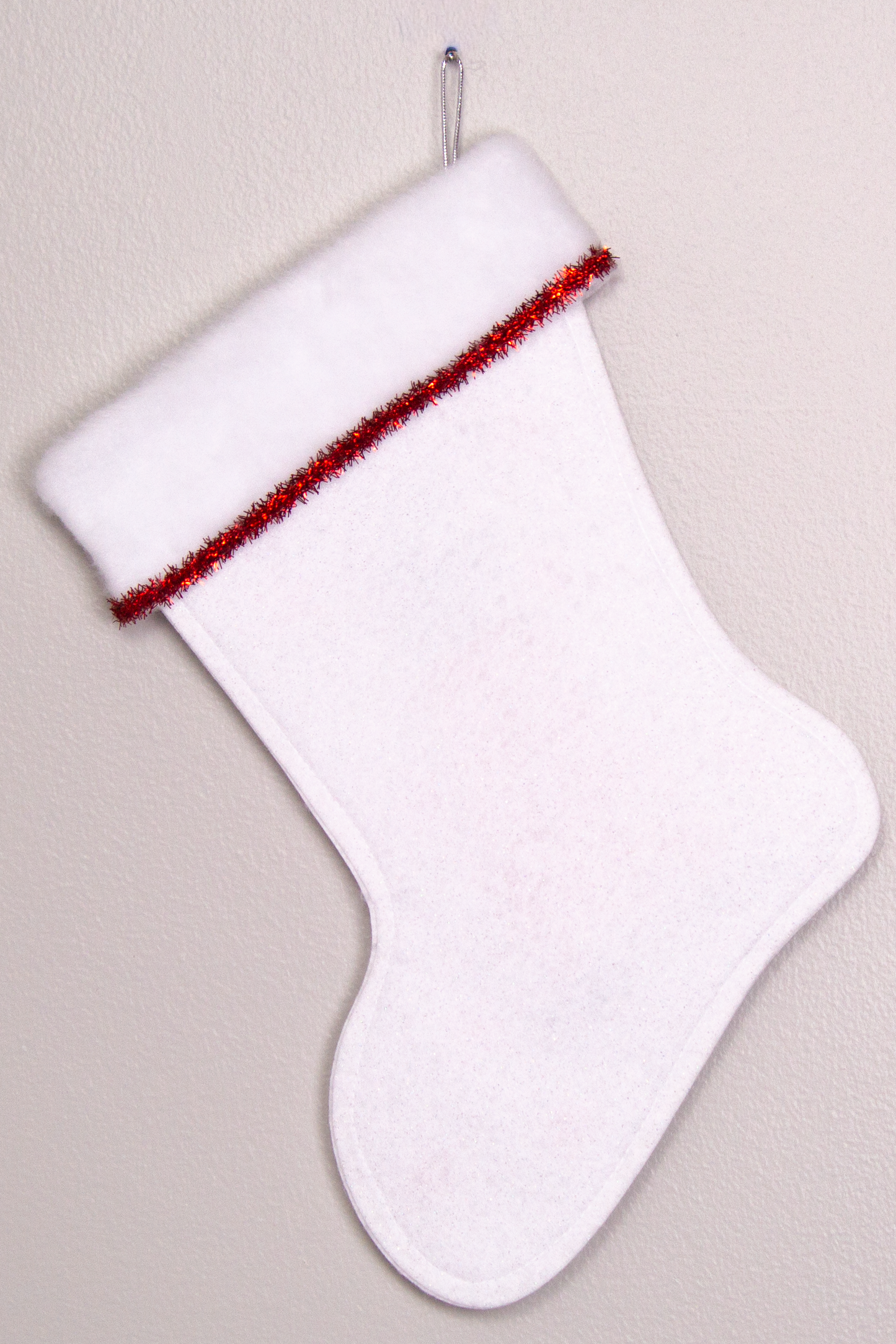 White glitter felt handmade Christmas stocking with tinsel ribbon and decoration in red & silver. (back of T-Rex stocking)
