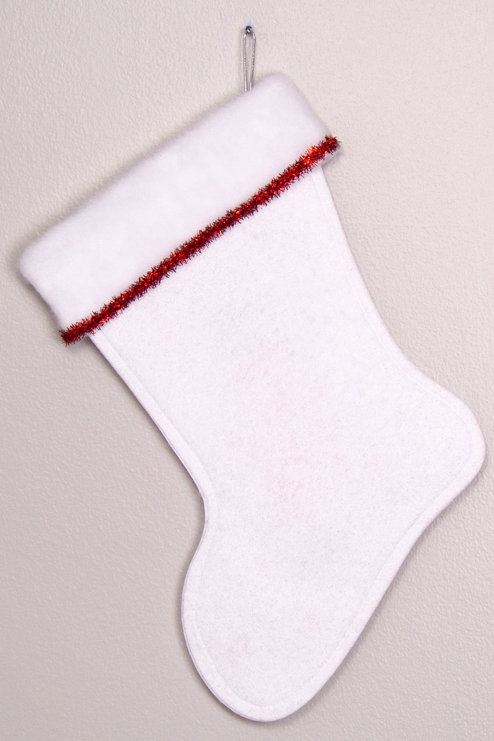 White glitter felt handmade Christmas stocking with tinsel ribbon and decoration in red & silver. (back of T-Rex stocking)