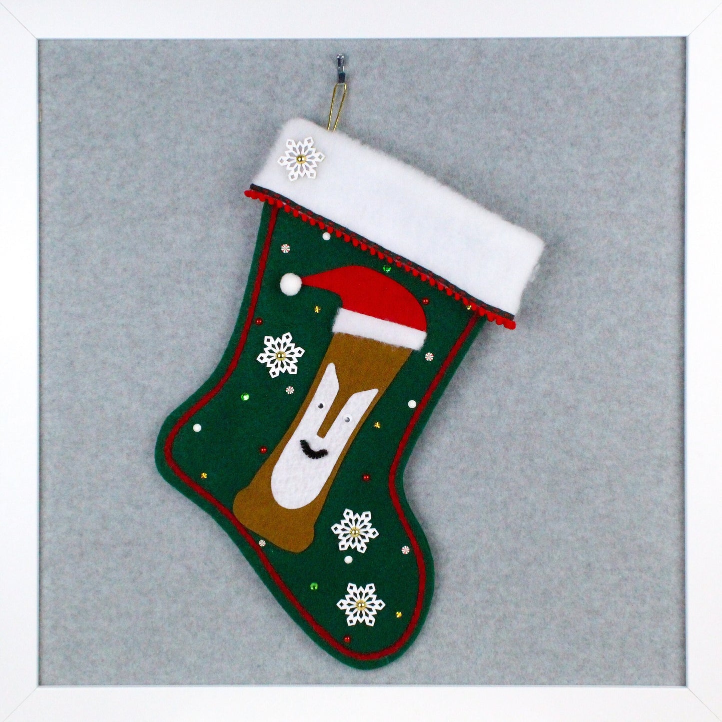 Tiki Bob with red Santa hat on dark green felt one of a kind handmade Christmas stocking with snowflakes and decorations in red, green, white and gold.