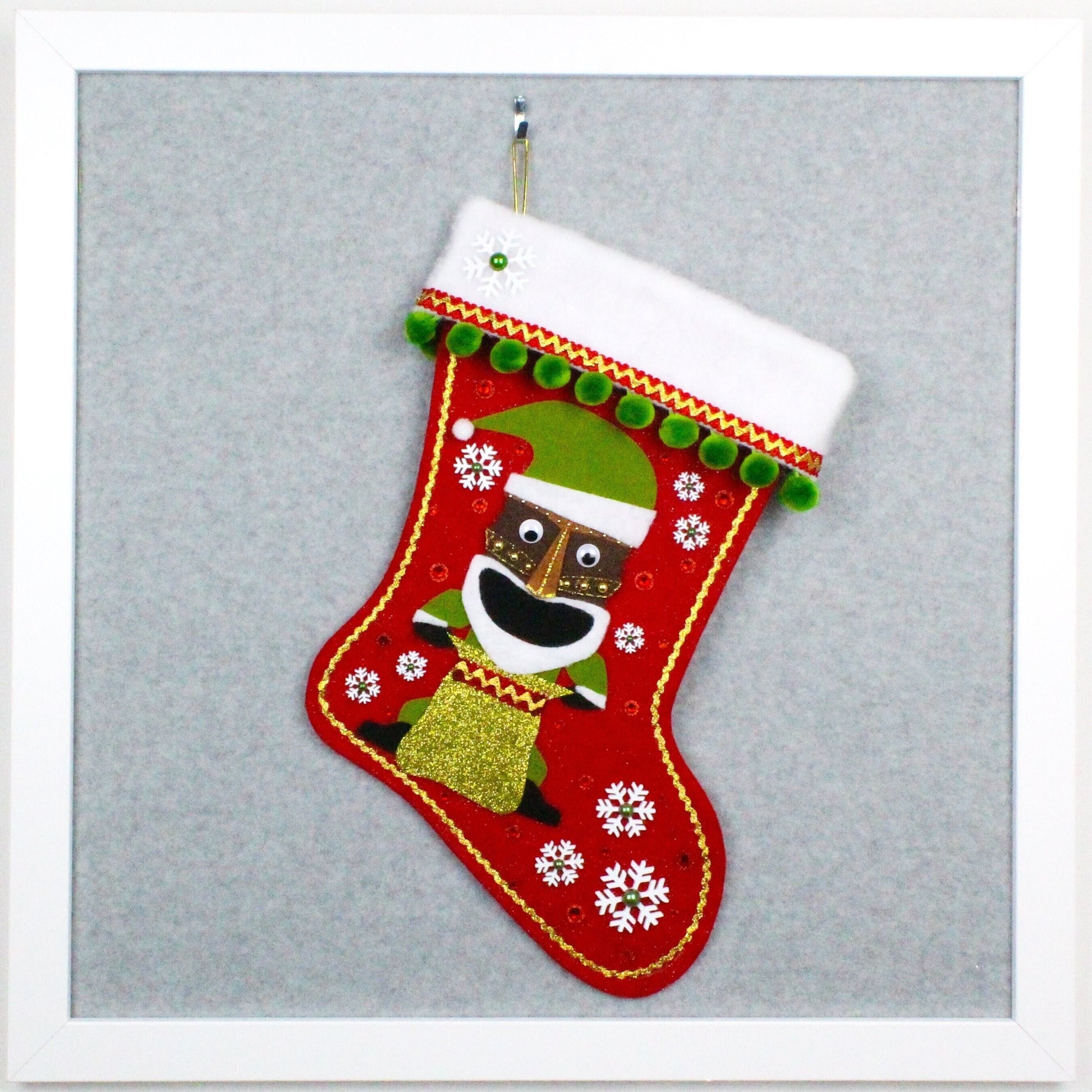 Tiki Santa on red glitter felt OOAK handmade Christmas stocking with pom poms, snowflakes and decorations in green, red, white and gold.