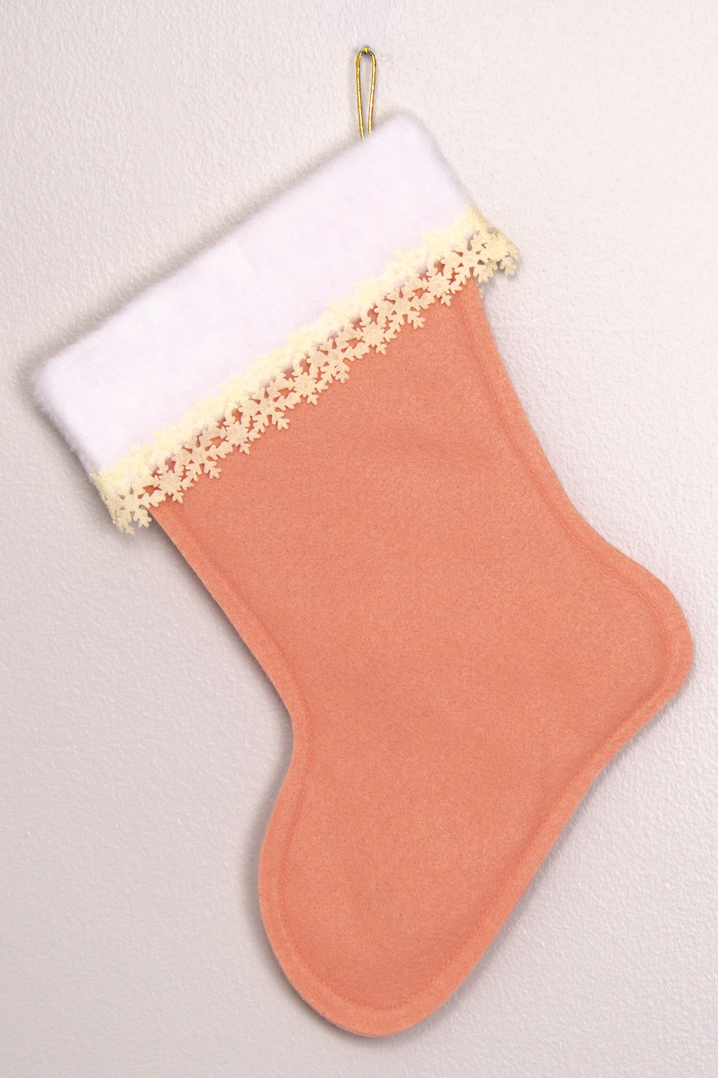 Coral felt handmade Christmas tree with delicate laser cut felt trim and decorated in cream & gold. (back of Tree stocking)