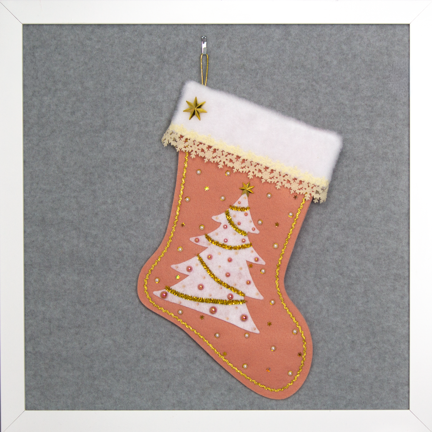 White felt tree on coral felt handmade Christmas tree with delicate laser cut felt trim, plastic star buttons, tinsel pipe cleaner, tiny snowflake sequins and decorated in cream, white, coral & gold. (front of Tree stocking)