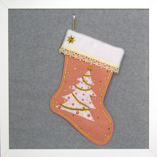 White felt tree on coral felt handmade Christmas tree with delicate laser cut felt trim, plastic star buttons, tinsel pipe cleaner, tiny snowflake sequins and decorated in cream, white, coral & gold. (front of Tree stocking)