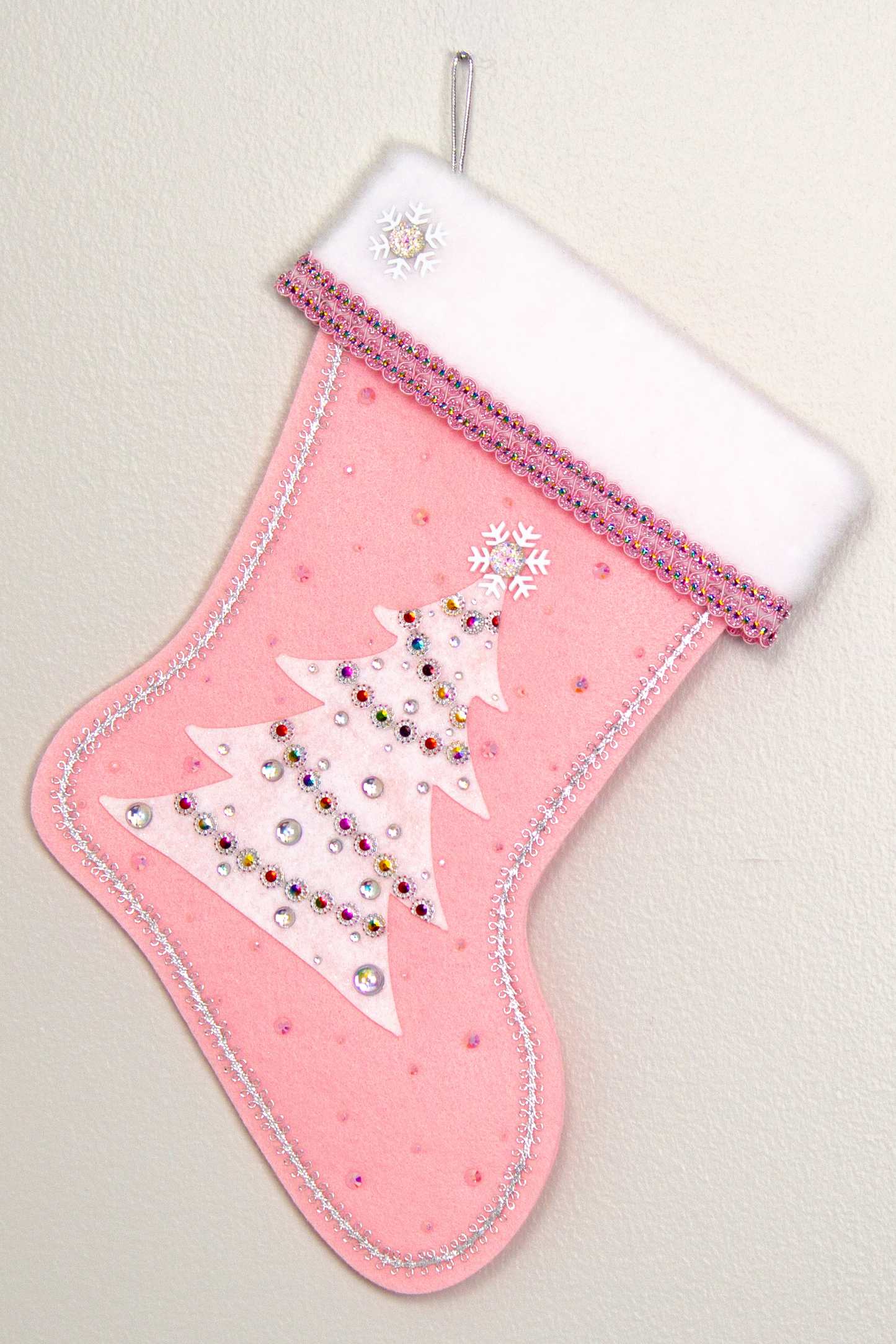 White glitter felt tree on light pink felt handmade Christmas stocking with snowflake buttons, large multifaceted rhinestones and decorated in white, clear, light pink, silver & multicolors. (front of Tree stocking)