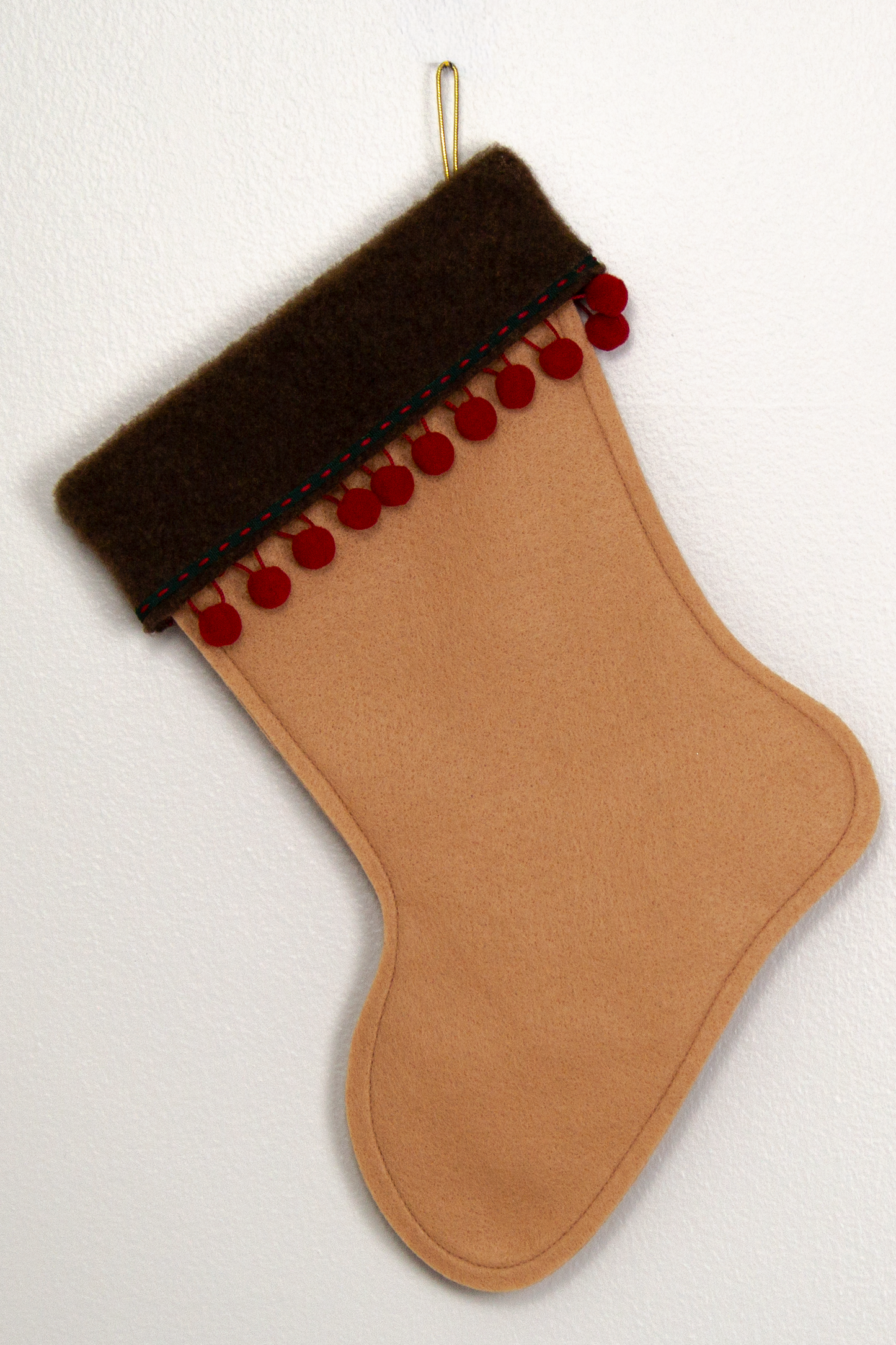 Tan felt handmade Christmas stocking with pom poms and decorated in red, green and gold. (back of Whippet dog stocking)