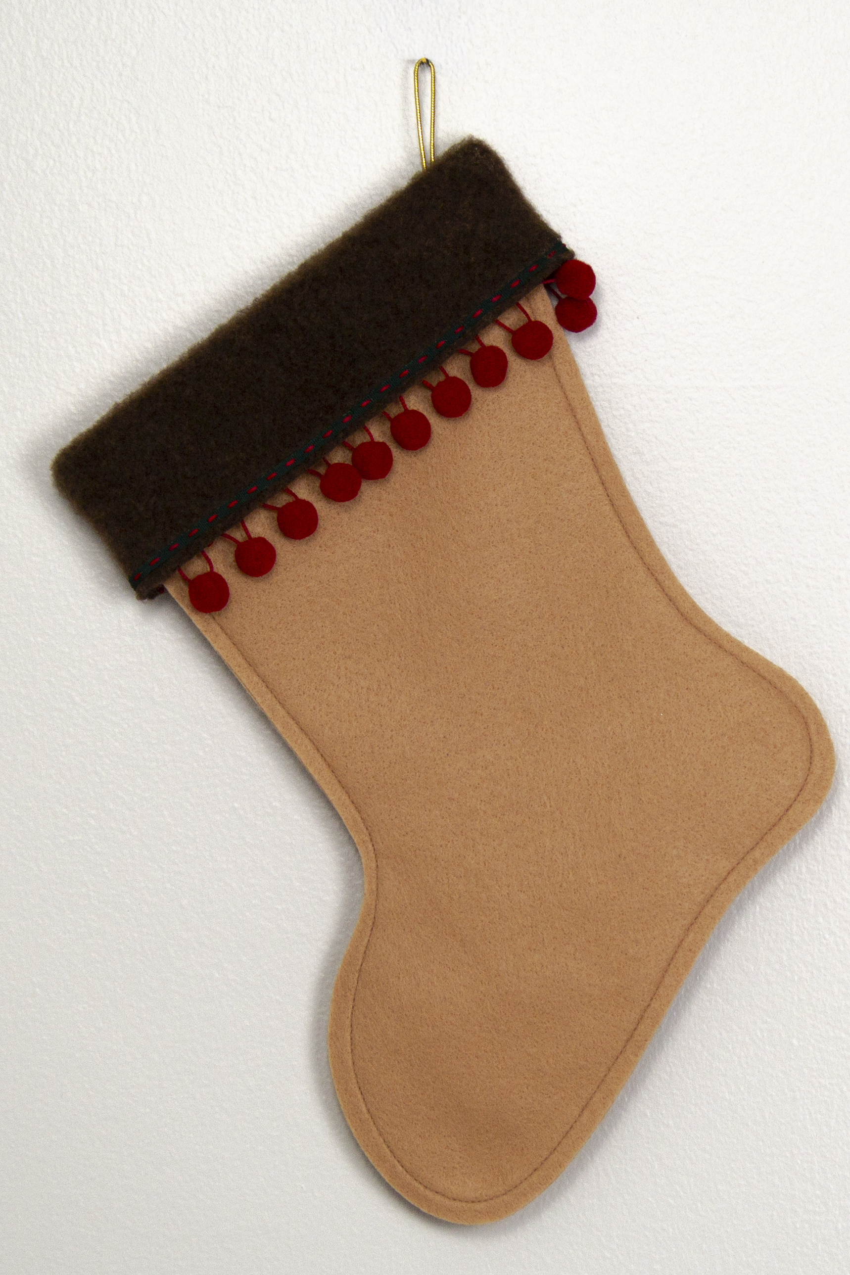 Tan felt handmade Christmas stocking with pom poms and decorated in red, green and gold. (back of Whippet dog stocking)