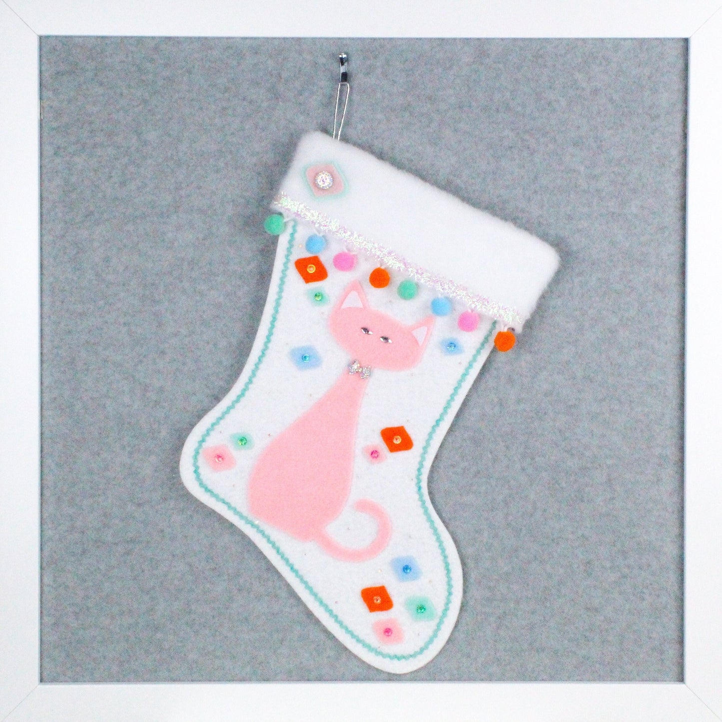 Light pink cat on glitter white felt handmade OOAK Christmas stocking with multicolor decorations including pom poms and onion ornament shapes.
