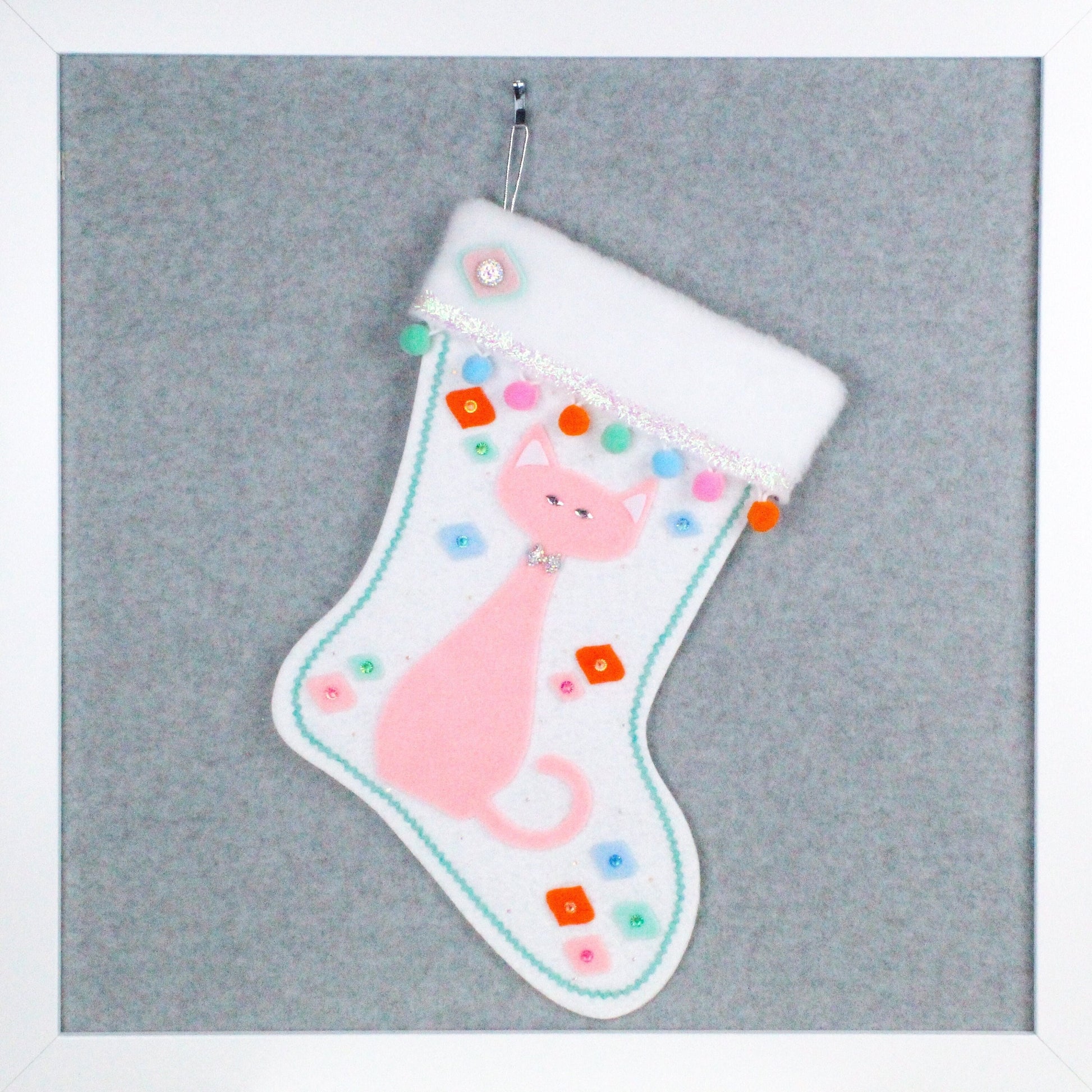 Light pink cat on glitter white felt handmade OOAK Christmas stocking with multicolor decorations including pom poms and onion ornament shapes.