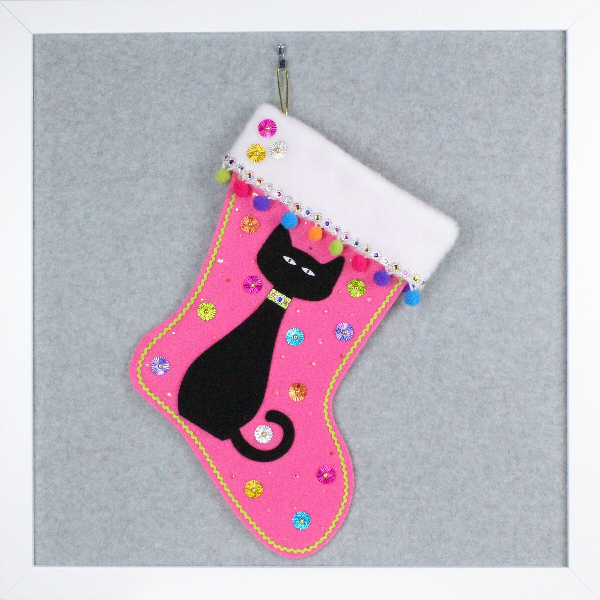 Black cat on candy pink felt one of a kind handmade Christmas stocking with multicolor and gold decorations.