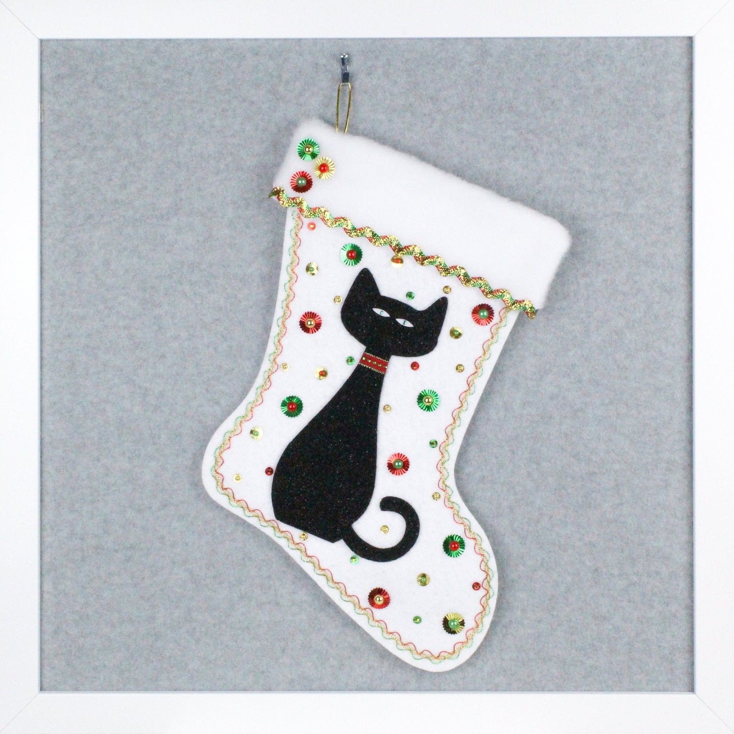 Black glitter cat on white glitter felt handmade one of a kind Christmas stocking with red, green and gold decorations.