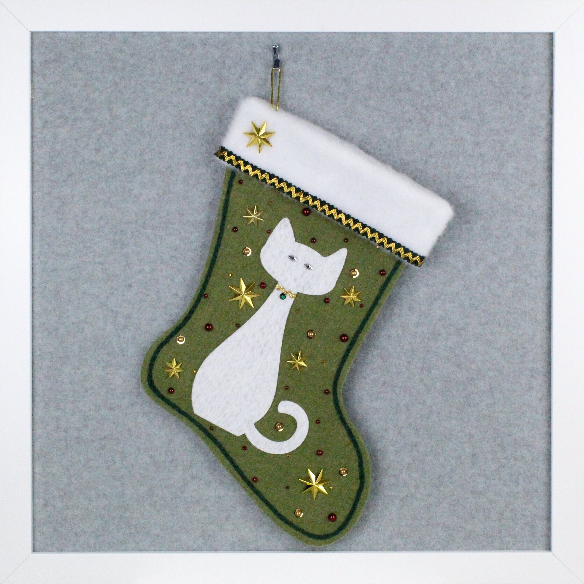 White cat on olive green felt handmade OOAK Christmas stocking with dark red, gold and dark green decorations.